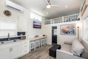 a kitchen and living room with white cabinets and a couch at Near Beach • Pool + Amenities • Sleeps 8 in Swain