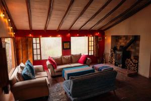 a living room with couches and a fire place at Finca Agrreste in Nemocón