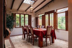a dining room with a red table and chairs at Finca Agrreste in Nemocón