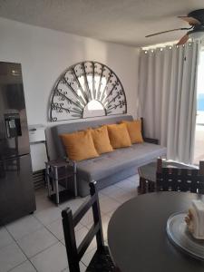 a living room with a couch and a table at Mision del Sol 302 in Bahía Kino +19 photos