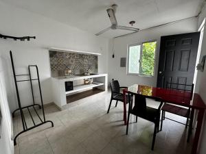 a dining room with a red table and chairs at The Soul Hostal in Playa del Carmen
