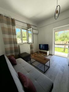 a living room with a couch and a table at Casa Verde in Marathias