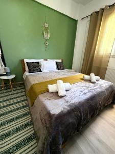 a bedroom with two beds with towels on them at Casa Verde in Marathias