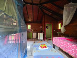 a bedroom with a bed and a table with a toy on it at 3 Rivers Eco Lodge in Rosalie