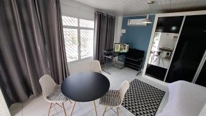 a room with a table and chairs and a desk at 10 Studios in São Paulo