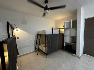 a room with a kitchen with a refrigerator at The Soul Hostal in Playa del Carmen