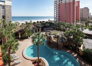 an overhead view of a pool with palm trees and the beach at Hampton Inn Oceanfront Jacksonville Beach in Jacksonville Beach