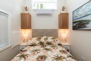 a bedroom with a bed with two night stands and two lamps at Pool • Fire Pit • Amenities • Sleeps 8 in Swain +54 photos