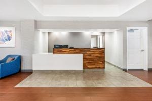 a lobby with a white table and a blue couch at Hampton Inn & Suites Lathrop in Lathrop +66 photos