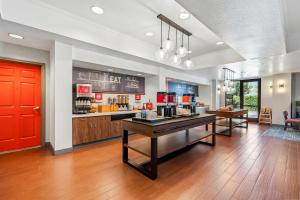 a coffee shop with a counter and a red door at Hampton Inn & Suites Lathrop in Lathrop