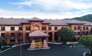a large building with a sign on the front of it at Hampton Inn & Suites Temecula in Temecula