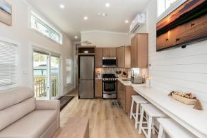 a kitchen with white walls and wooden cabinets at Pool • Fire Pit • Amenities • Sleeps 8 in Swain