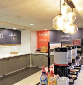 a restaurant with a counter with drinks on it at Hampton Inn & Suites Seal Beach in Seal Beach