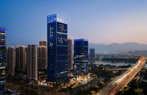 a city skyline with tall buildings and a freeway at DoubleTree by Hilton Zhangzhou in Zhangzhou