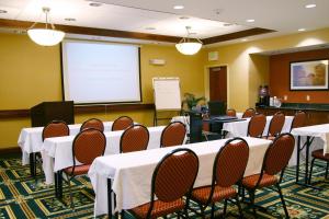 a conference room with tables and chairs and a screen at Hampton Inn & Suites Seal Beach in Seal Beach +21 photos