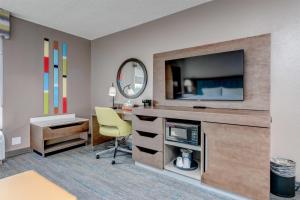 a room with a desk with a television and a chair at Hampton Inn Morgantown in Morgantown