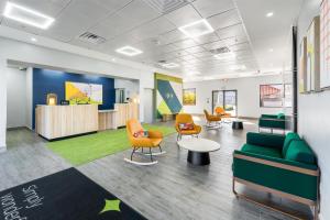 an office with chairs and a couch and a table at Spark by Hilton Ponce in Ponce