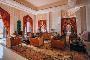 a large living room with couches and chairs at Al Husn Hotel Muscat - managed by Hilton in Muscat