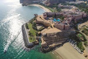 an aerial view of a resort near the ocean at Al Husn Hotel Muscat - managed by Hilton in Muscat