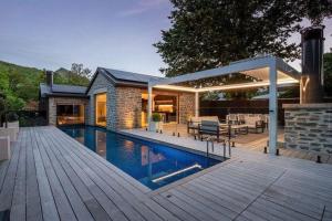 a house with a swimming pool and a patio at The Spire Hotel in Queenstown