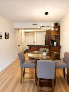 a kitchen and dining room with a table and chairs at Alpine Hideaway at Alpine Village in Canmore