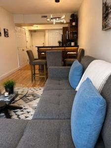 a living room with a couch and a dining room at Alpine Hideaway at Alpine Village in Canmore