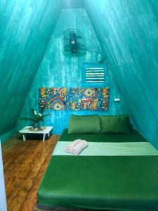 a bedroom with a bed in a tent at MyLove Siargao Village in General Luna