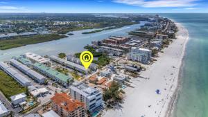 an aerial view of a beach with a yellow sign at Oceanview - Steps to Beach - King Suite - Pool - Arcade in Clearwater Beach