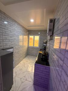 a bathroom with a purple counter and a wall at Classico Apartments in Tan-Tan Plage +2 photos