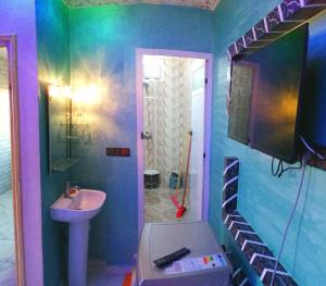a bathroom with a sink and a staircase in it at Classico Apartments in Tan-Tan Plage
