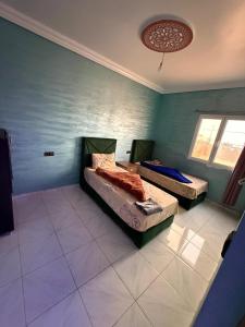 a bedroom with two beds in a room at Classico Apartments in Tan-Tan Plage