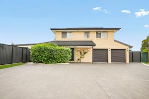 a house with a driveway in front of it at Pacific Palms Retreat - Entire Home in Plumpton Sleeps 9 - 8-Car Parking Near Eastern Creek in Rooty Hill
