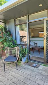 a wicker chair sitting on the patio of a house at Stay on Sooning in Nelly Bay