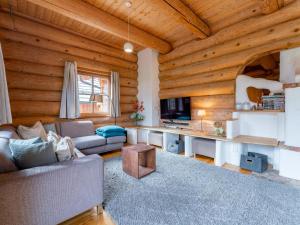 a living room with a couch and a tv at Janna in Mauterndorf