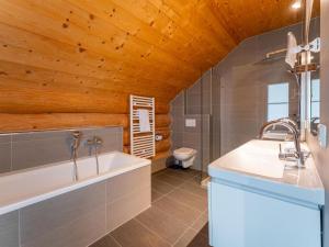 a bathroom with a tub and a sink and a toilet at Janna in Mauterndorf +56 photos