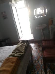 a bedroom with a bed and a window and a sink at Hôtel des cedresazrou in Azrou