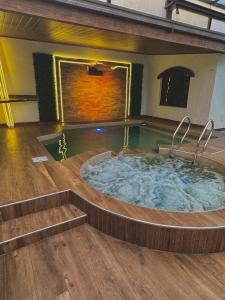 a large jacuzzi tub in a room with wooden floors at TheBunker in Cochabamba
