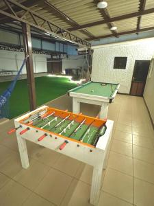 a ping pong table sitting in a room with a table at TheBunker in Cochabamba