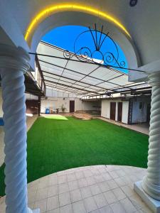 an archway of a building with a green lawn at TheBunker in Cochabamba