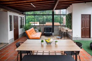 a patio with a table and chairs and a fireplace at Coliving Compostela in Medellín