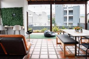 a living room with a couch and a table at Coliving Compostela in Medellín