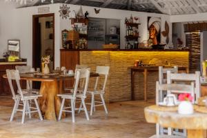 a restaurant with a table and chairs in a room at Controvento Boutique Hotel - Yoga Kitesurf in Cumbuco