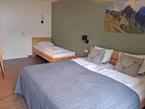 a bedroom with a large bed and two twin beds at Emma Top 1 in Dienten am Hochkönig