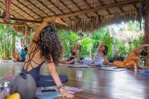 a group of women sitting on the floor in a yoga class at Controvento Boutique Hotel - Yoga Kitesurf in Cumbuco