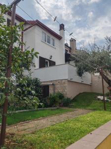 a large white house with a grass yard at Apartments with parking space Dajla, Novigrad - 6935 in Novigrad Istria