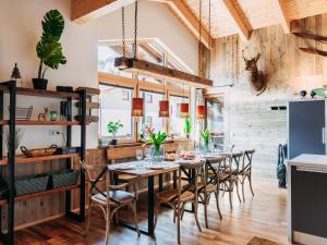 a dining room with a table and chairs at Bernkogel Penthouse in Rauris +21 photos