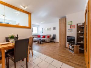a living room with a table and a dining room at Selmas in Zell am See +30 photos