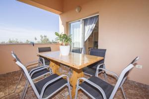 a dining room with a wooden table and chairs at Apartments Alen in Fažana