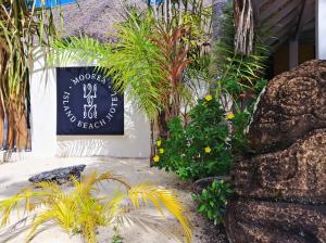 a sign on the side of a building with plants at Moorea Island Beach Hotel in Moorea +136 photos