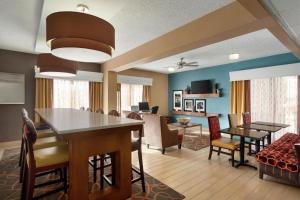 a living room with tables and chairs and a dining room at Hampton Inn Phoenix-Chandler in Chandler